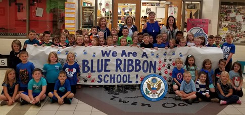 Twin Oak students and teachers in front of Blue Ribbon School banner.