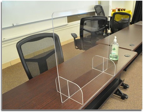 Plexiglass barrier installed on conference desk.