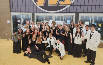MVHS Chorale posing together while holding up "1"s.