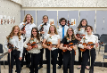 The 2021 Orchestra Seniors pose in two rows for a photograph with their instruments.