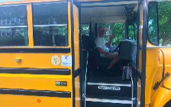School Bus driver welcoming students.
