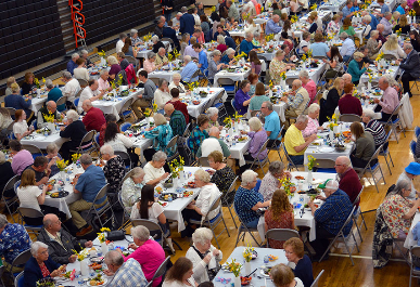 Senior Citizens enjoying lunch in the Mount Vernon Gymnasium.