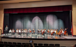 The MVMS 8th Grade Orchestra sits onstage at Big Walnut High School.