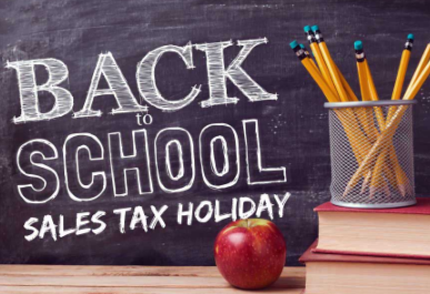 Back to school sales tax holiday on blackboard with apple, books and pencils.