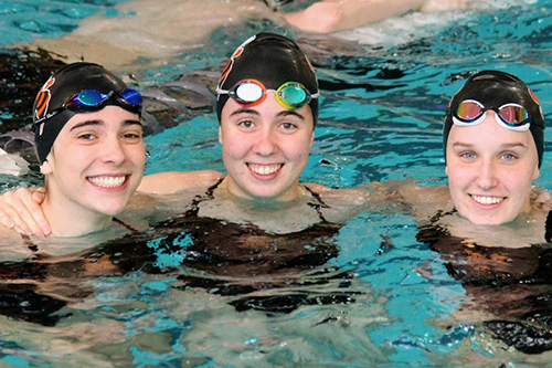 Three members of the girls swimming team in the pool at Kenyon College.