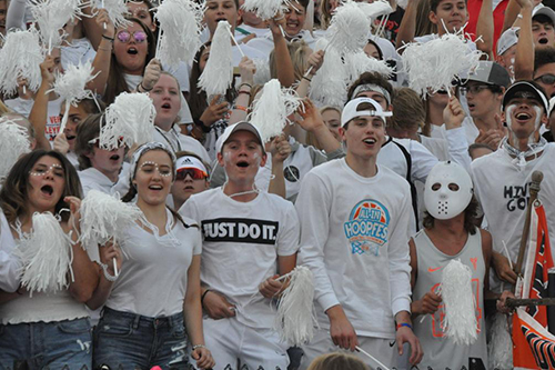 Students cheering in the HIVE during a football game.