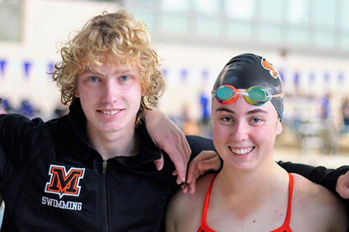 Swimmers on the pool deck.