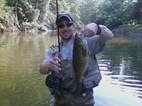 Mr. Farmer holding smallmouth bass while fly fishing on the Kokosing.