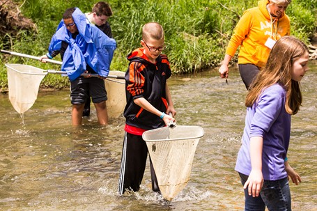Students sampling a stream for aquatic life.