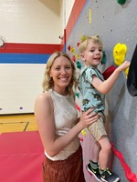 Mrs. Barbour and her son on the climbing wall.